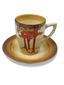 Clarice Cliff CORAL FIRS, a Lynton shape coffee can and saucer. Art Deco circa 1933.