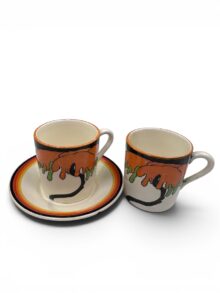 Clarice Cliff x2 Woodland tankard shape coffee cans & matched saucer, circa 1930.